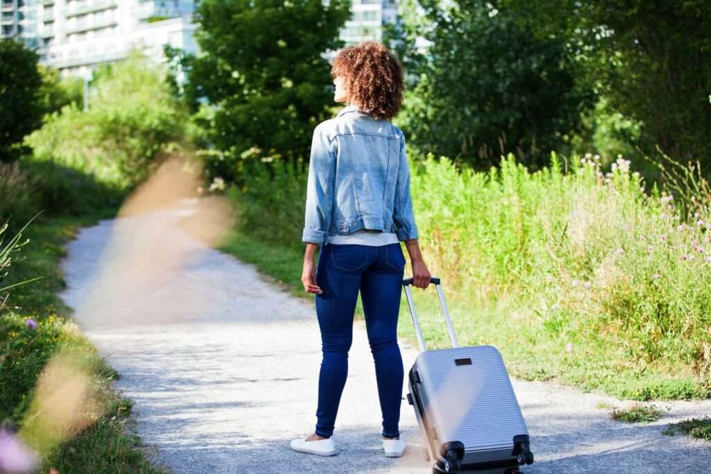 woman pulling carry-on bag