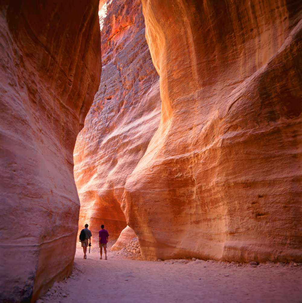 The Siq, the narrow slot-canyon that serves as the entrance passage to the hidden city of Petra, Jordan, seen here with Exodus Travels
