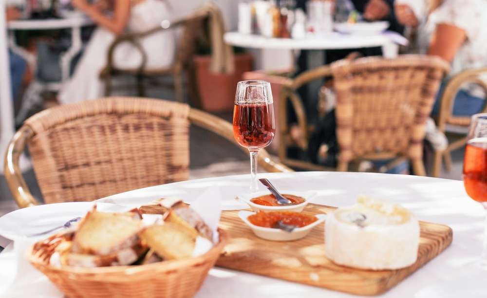 A glass of traditional Portuguese sweet wine moscatel with cheese and bread in a cafe on tour with Exodus Travels
