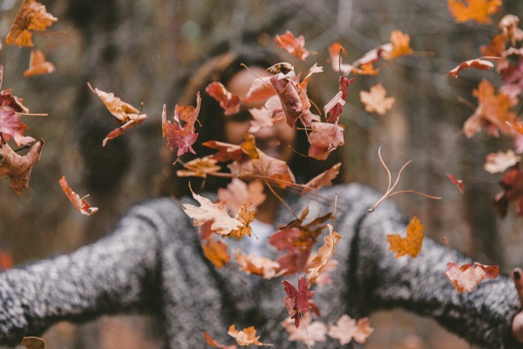 woman walking in fall leaves