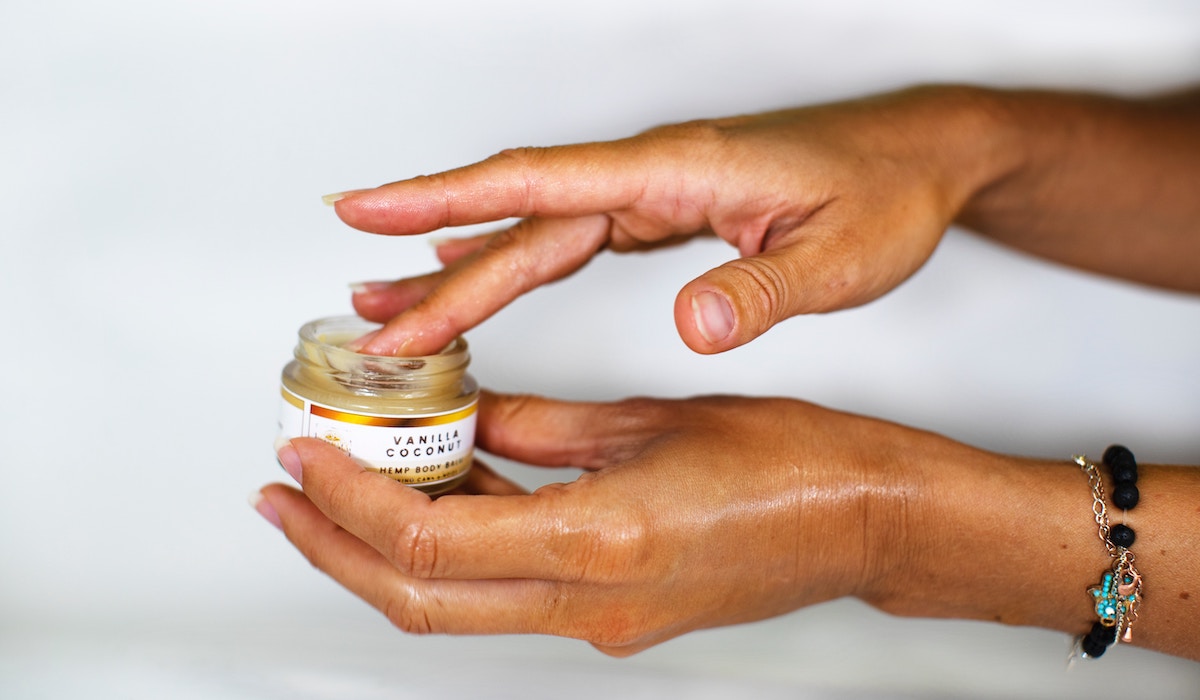 person holding white labeled CBD bottle